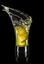 gold tequila shot with lime slice and splash Royalty Free Stock Photo