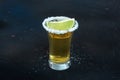 Gold tequila shot, with a salt rim and a lime slice, an angle close-up view Royalty Free Stock Photo
