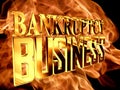 Gold text bankruptcy business on fire background Royalty Free Stock Photo