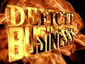 Gold text deficit business on fire background