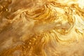 A gold textured surface with a smooth, reflective finish, showcasing swirling, marbled patterns Royalty Free Stock Photo