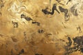A gold textured surface with a smooth, reflective finish, showcasing swirling, marbled patterns Royalty Free Stock Photo