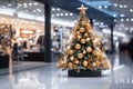 Gold themed Christmas tree in a shopping mall displayed on a panoramic blurred banner