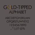 Gold-tipped alphabet with numbers and punctuation marks.