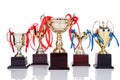 Gold trophies with decorative ribbons on white background Royalty Free Stock Photo