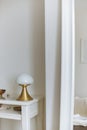 Gold vase on white table and mirror white background