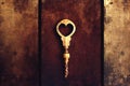 Gold vintage wrench with heart-shaped neckline on wooden background.