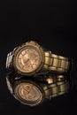 Gold watch on a plastic background Royalty Free Stock Photo