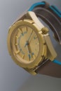 Gold watch on a plastic background Royalty Free Stock Photo