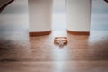 Gold wedding ring between pair of a white shoes Royalty Free Stock Photo