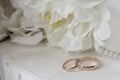 Gold wedding rings on a background of white decorative flowers Royalty Free Stock Photo