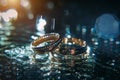 Gold wedding rings of bride and groom in shiny water spray, bright background, selective focus. Wedding accessories and jewelry Royalty Free Stock Photo