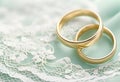 Gold wedding rings on lace textile invitation card with copy space Royalty Free Stock Photo