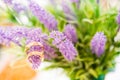 gold wedding rings on lavender flowers nature blur background.