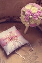 Gold wedding rings lie on a decorative silk pillow with pink satin ribbons next to the bride`s bouquet. Toning with the style of Royalty Free Stock Photo