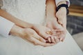 gold wedding rings on the palms of the bride. the groom holds the bride's hands Royalty Free Stock Photo