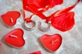 Red heart candles . Red rose petals . Gold wedding rings Royalty Free Stock Photo