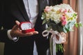 gold wedding rings in a red velvet box on the background of the bridal bouquet. close-up  macro Royalty Free Stock Photo