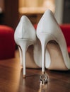 Gold wedding rings under heel shoes bride Royalty Free Stock Photo