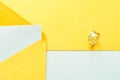 Gold wedding rings on the yellow letter invitation on the white background Royalty Free Stock Photo