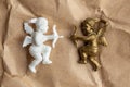 Gold and white cupid on a background of kraft paper