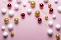 Gold and white glitter ball decoration with red Christmas bauble on pink background. Royalty Free Stock Photo