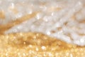 Gold and white shiny festive background. Shiny golden and silver glitter, sparkles, bokeh lights Royalty Free Stock Photo