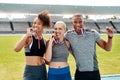 Gold for the win. Cropped portrait of a diverse group of athletes standing together and biting their medals after