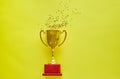 Gold winners trophy with golden shiny stars on yellow background Royalty Free Stock Photo