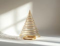 A gold wire sculpture shaped like a conical spiral rests on a flat surface AI Generated image Royalty Free Stock Photo
