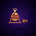 Gold Witch cauldron and magic stone icon isolated on black background. Vector