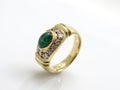 Gold womenÃÂ´s ring witch diamonds and green gem