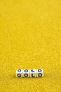 Gold word formed by white dices with black letters laying on golden background