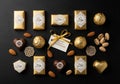Gold-wrapped chocolates arranged on a dark surface, featuring Arabic-script labels indicating they Royalty Free Stock Photo