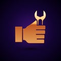 Gold Wrench spanner icon isolated on black background. Vector