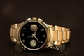 Gold wrist watch and bracelet, close-up on black Royalty Free Stock Photo