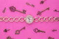 Gold wrist watch with diamonds among keys Royalty Free Stock Photo