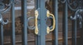 Gold wrought iron door handle in a luxury district of Paris Royalty Free Stock Photo