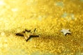 Golden abstract background with stars, lights, bokeh. Christmas celebration. Glitter texture card for new year party Royalty Free Stock Photo