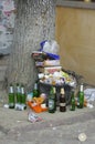 Golden age of consuming. Overflowing trash can on a street, empty bottles of alchohol, food boxes, plastic bags. Kyiv