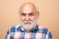 Golden age grandfather. Mature bald man with grey beard on studio background. Portrait of senior elderly caucasian old Royalty Free Stock Photo