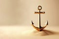 Golden anchor on a sandy background. Space for text. Royalty Free Stock Photo