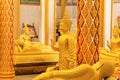 Golden ancient Buddha statues in different poses in temple Royalty Free Stock Photo