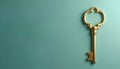 Golden antique key rests on teal background. This object symbolizes opportunity wealth and finding solutions. Offers ample empty Royalty Free Stock Photo