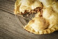 Golden Apple Pie on Rustic Barnwood With One Slice Gone