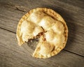 Golden Apple Pie on Rustic Barnwood With One Slice Gone