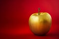 Golden Apple on Vibrant Red Background, Symbol of Temptation