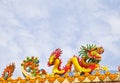 Golden artistic grand yellow Asian dragon statue on the roof of a temple Royalty Free Stock Photo