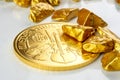 Golden austrian philharmoniker one ounce coin laying on a heap of golden nuggets, golden ore