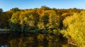 Golden autumn background, aerial view of forest with yellow trees and beautiful lake landscape from above, Kiev, Goloseevo forest Royalty Free Stock Photo